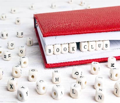 beads surrounding red notebook with beads inside that say book club